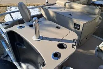 Slide: The Image of 2014 Bennington S21 boat interior with seating and cup holders. - 14