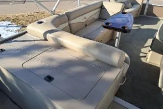Slide: The Image of 2014 Bennington S21 boat interior with beige seating and a small table. - 15