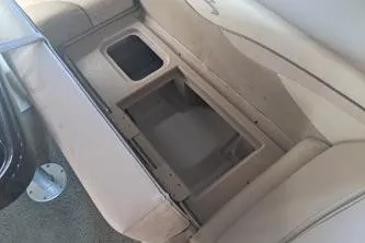 Slide: The Image of 2014 Bennington S21 boat seat storage compartment with beige upholstery. - 23