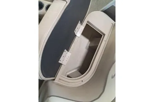 Slide: The Image of 2014 Bennington S21 boat storage compartment with open lid, showcasing interior space. - 24