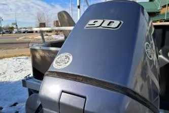 Slide: The Image of 2014 BENNIGTON S21 boat with 90 HP engine in snowy outdoor setting. - 3