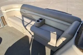 Slide: The Image of 2014 BENNIGTON S21 boat interior with beige seating and cup holders. - 9