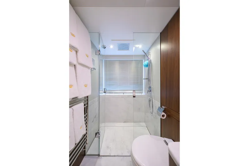 Slide: The Image of Luxurious bathroom in 2021 Princess Y78 yacht with glass shower and elegant wood accents. - 26