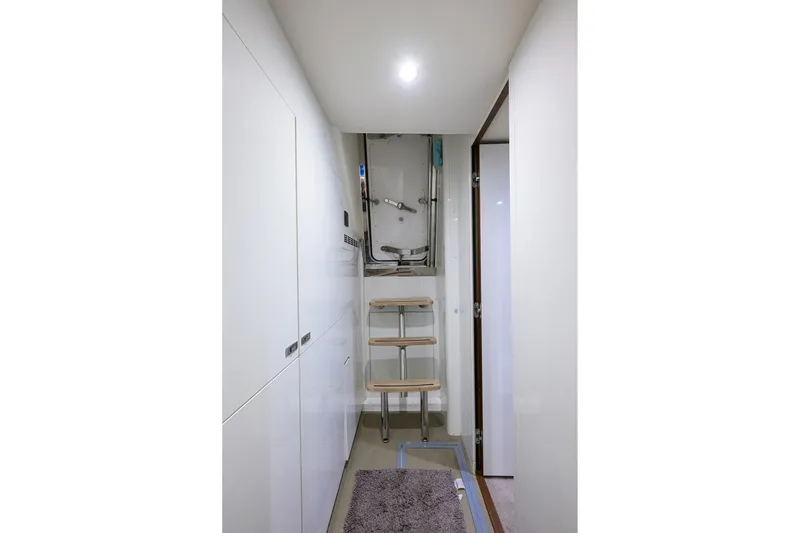 Slide: The Image of Interior of 2021 Princess Y78 yacht with sleek white cabinetry and compact ladder. - 44