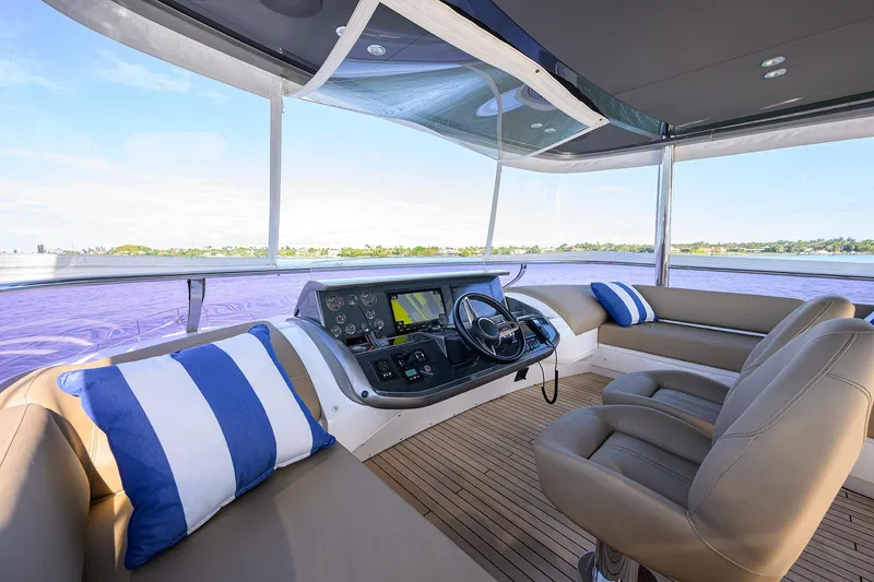 Slide: The Image of Luxurious 2021 Princess Y78 yacht helm with plush seating and scenic water views. - 50