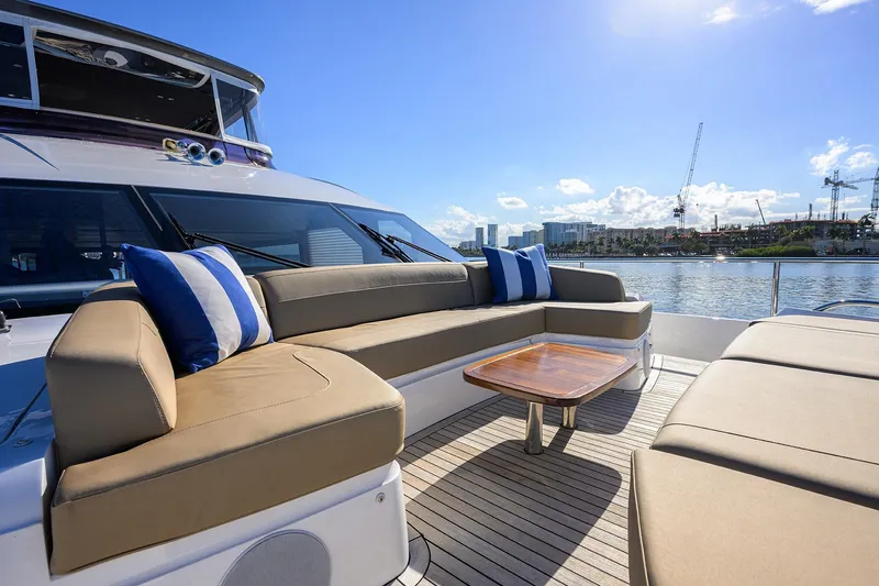Slide: The Image of Luxurious 2021 Princess Y78 yacht deck with comfortable seating and scenic waterfront view. - 69