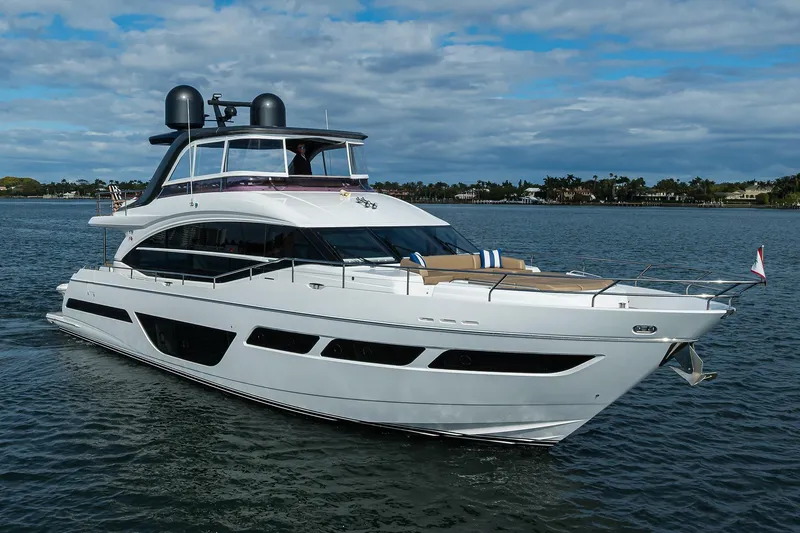 Slide: The Image of Luxury 2021 Princess Y78 yacht cruising on a serene waterway under a partly cloudy sky. - 84