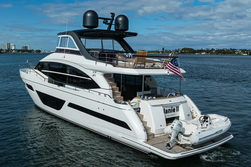 Slide: The Image of Luxurious 2021 Princess Y78 yacht cruising on open water, featuring sleek design and American flag. - 87