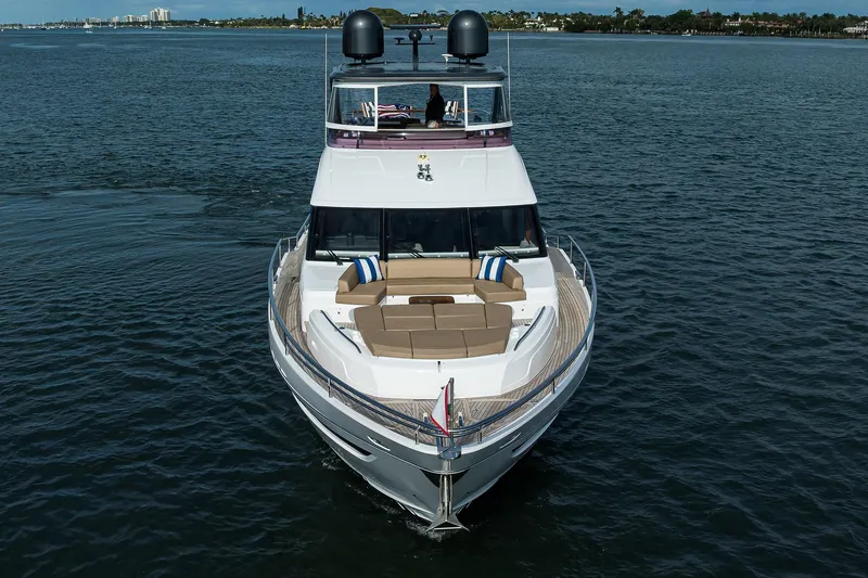 Slide: The Image of Luxury 2021 Princess Y78 yacht cruising on open water, featuring elegant design and spacious deck. - 92