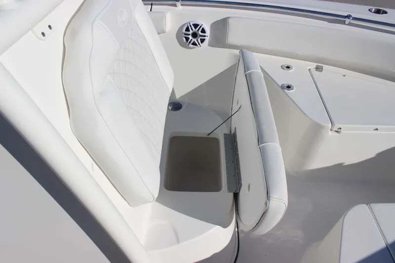 Slide: The Image of 2026 Key West 219 FS boat interior with white cushioned seating and storage compartment. - 16