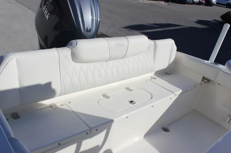 Slide: The Image of 2026 Key West 219 FS boat interior with white cushioned seating and Yamaha engine. - 18