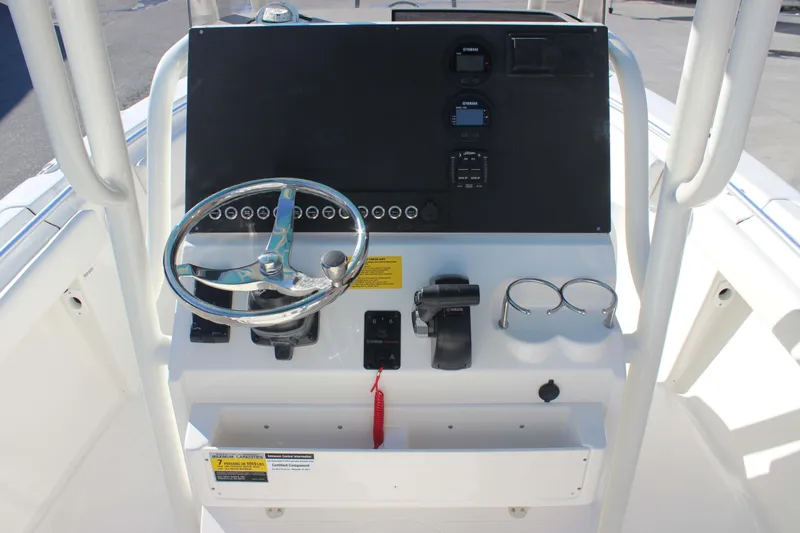 Slide: The Image of Center console of 2026 Key West 219 FS boat with steering wheel and controls. - 6