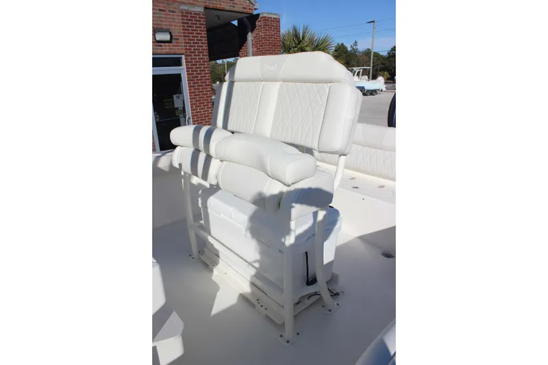 Slide: The Image of 2026 Key West 219 FS boat with white cushioned seating in a sunny outdoor setting. - 7