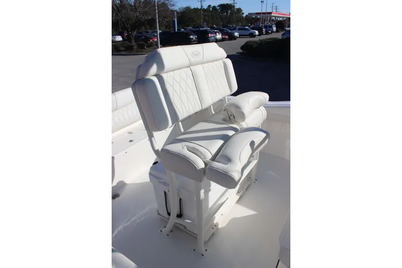 Slide: The Image of 2026 Key West 219 FS boat with white cushioned seating in a parking lot. - 8