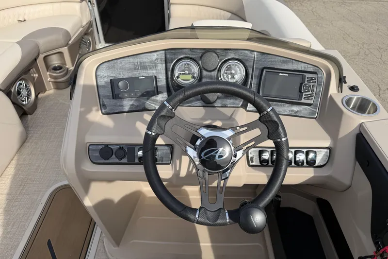 Slide: The Image of 2023 Avalon LSZ QUAD LOUNGE boat dashboard with steering wheel and control panel. - 10