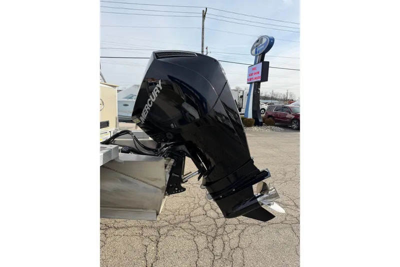 Slide: The Image of 2023 Avalon LSZ QUAD LOUNGE with Mercury outboard motor in parking lot. - 11