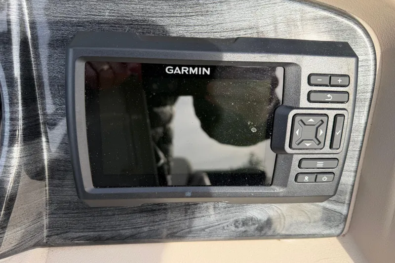 Slide: The Image of Garmin device on 2023 Avalon LSZ QUAD LOUNGE dashboard, featuring control buttons. - 13
