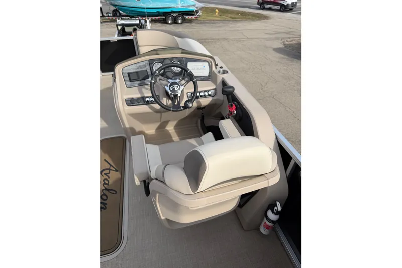 Slide: The Image of 2023 Avalon LSZ QUAD LOUNGE boat helm with steering wheel and controls. - 14