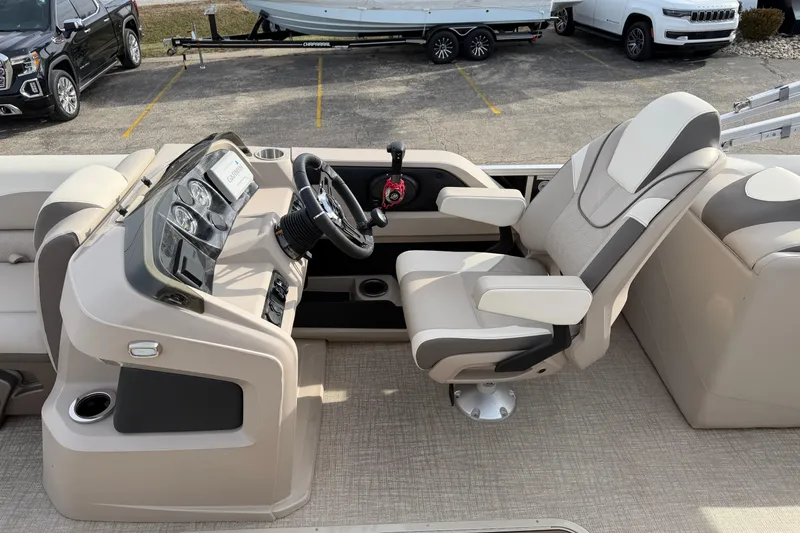 Slide: The Image of 2023 Avalon LSZ QUAD LOUNGE boat interior with captain's chair and control panel. - 15