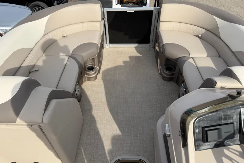 Slide: The Image of 2023 Avalon LSZ QUAD LOUNGE interior with beige seating and cup holders. - 6