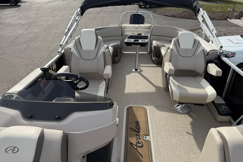 Slide: The Image of 2023 Avalon LSZ QUAD LOUNGE boat interior with luxurious seating and modern helm. - 8