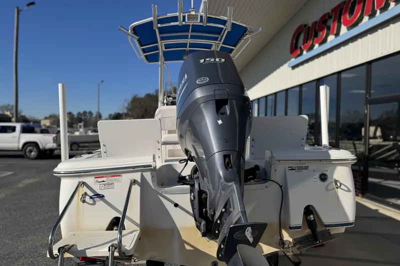 Slide: The Image of 2013 Sea Hunt BX 20 BR boat with Yamaha 150 outboard motor, parked outside a dealership. - 4