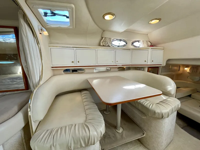 Slide: The Image of Interior of a 2001 Sea Ray Sundancer 310 with dining table and seating area. - 11