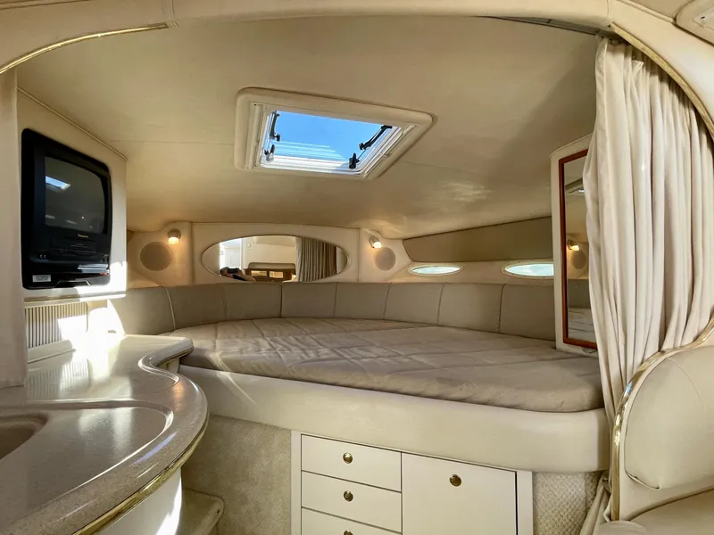 Slide: The Image of Interior of a 2001 Sea Ray Sundancer 310 yacht with bed and TV. - 12