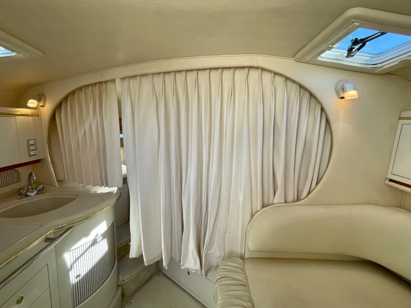 Slide: The Image of Interior of a 2001 Sea Ray Sundancer 310 yacht with curtains and seating area. - 13