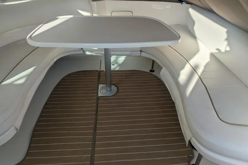 Slide: The Image of 2001 Sea Ray Sundancer 310 interior with white seating and wooden flooring. - 37