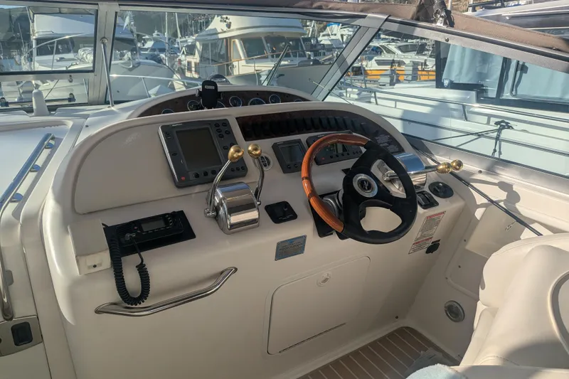 Slide: The Image of 2001 Sea Ray Sundancer 310 helm with steering wheel and navigation controls. - 45