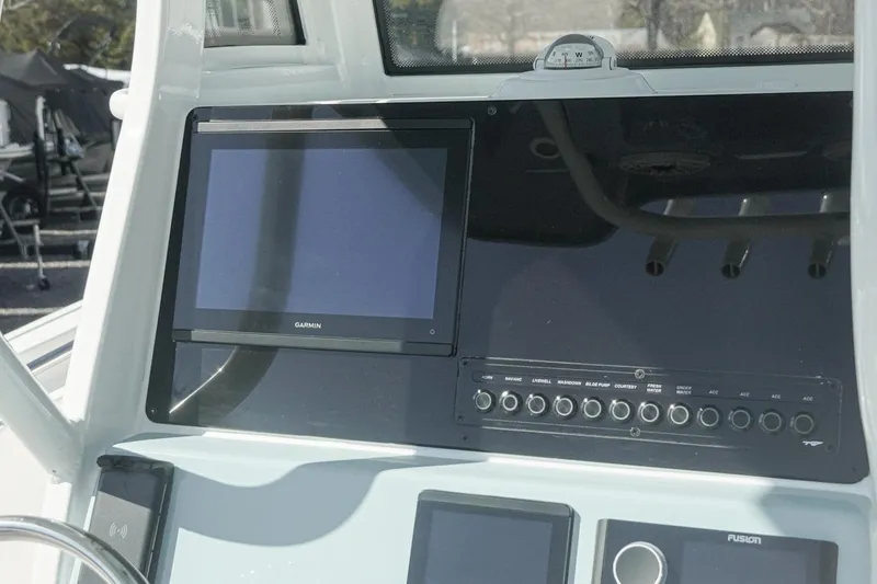 Slide: The Image of 2026 Tidewater 232 CC Adventure boat dashboard with Garmin display and control panel. - 10