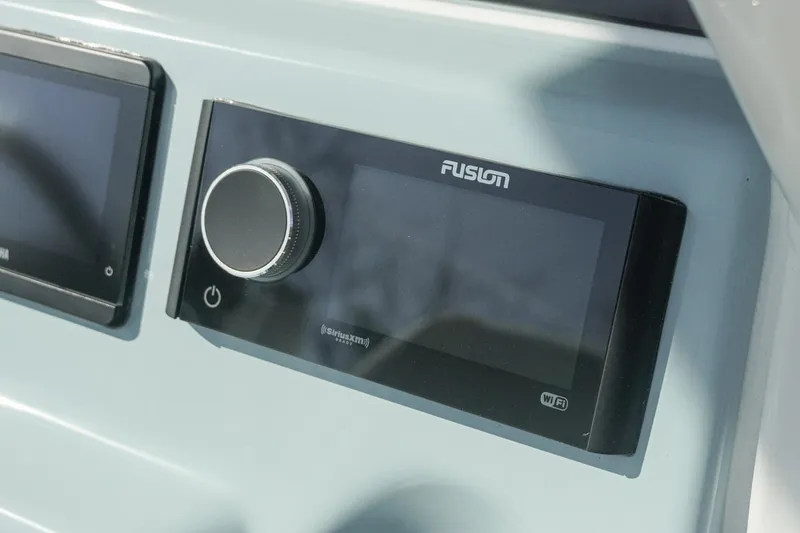Slide: The Image of Close-up of Fusion audio system on 2026 Tidewater 232 CC Adventure boat dashboard. - 11