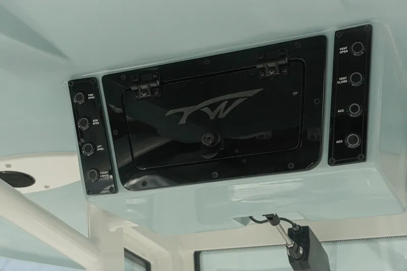Slide: The Image of 2026 Tidewater 232 CC Adventure boat control panel with switches and logo. - 13