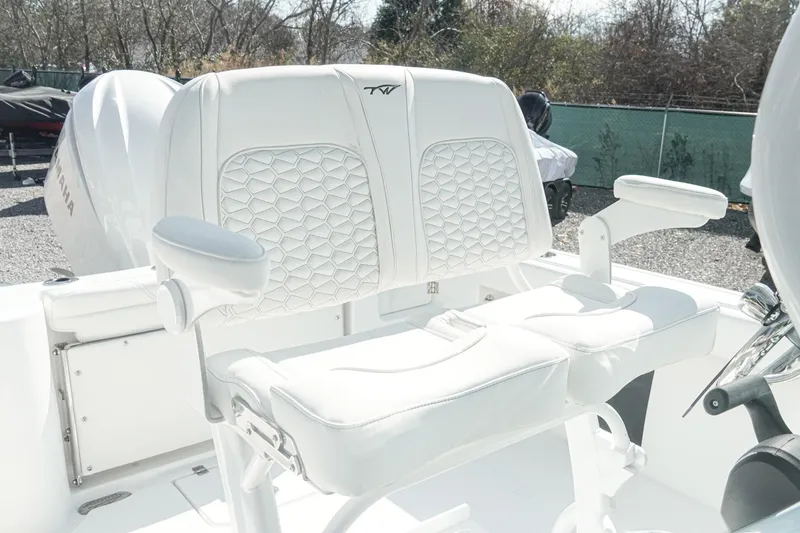 Slide: The Image of 2026 Tidewater 232 CC Adventure boat with white cushioned seating and armrests. - 14