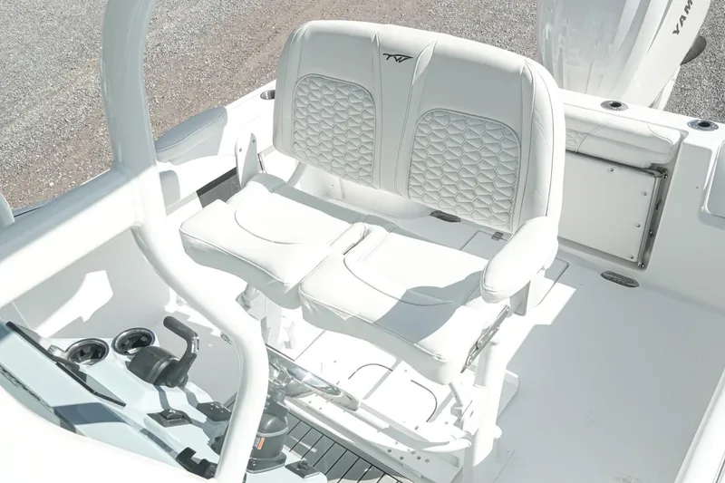 Slide: The Image of 2026 Tidewater 232 CC Adventure boat interior with white cushioned seating. - 16