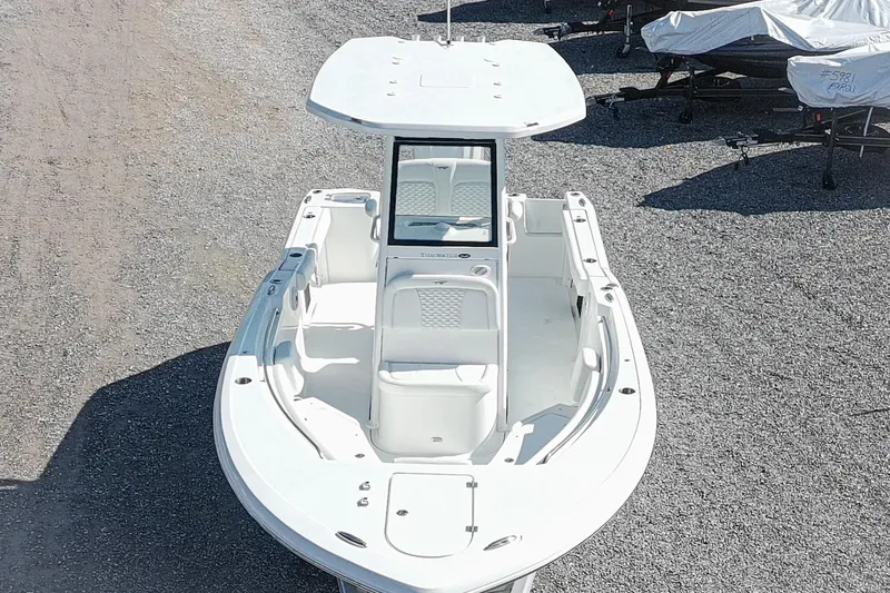 Slide: The Image of 2026 Tidewater 232 CC Adventure boat, aerial view, parked on gravel. - 2