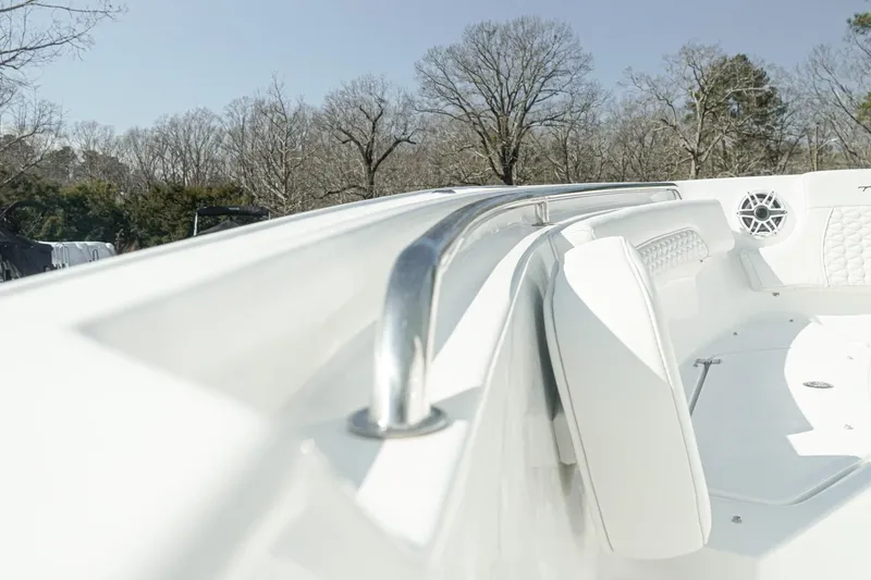 Slide: The Image of 2026 Tidewater 232 CC Adventure boat interior with white seating and stainless steel rail. - 21
