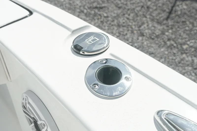 Slide: The Image of 2026 Tidewater 232 CC Adventure boat detail with cup holder and rod holder. - 22