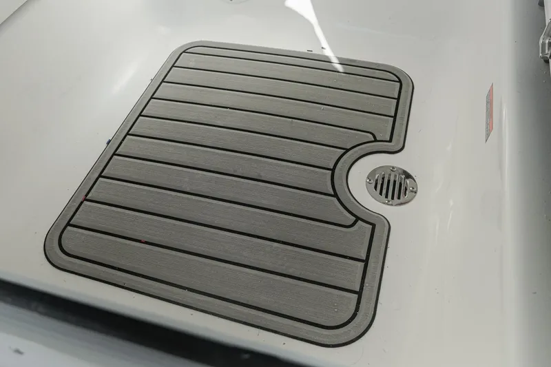 Slide: The Image of 2026 Tidewater 232 CC Adventure boat deck with non-slip mat and drain. - 25