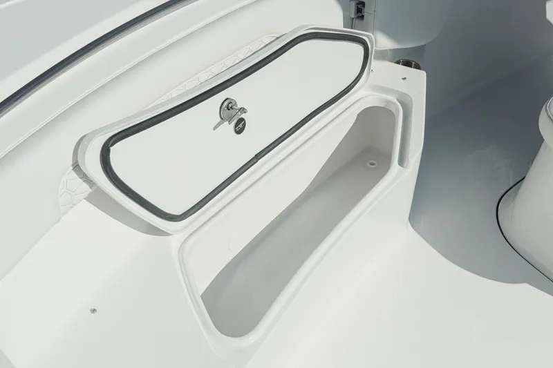 Slide: The Image of Storage compartment on 2026 Tidewater 232 CC Adventure boat, featuring secure lock and sleek design. - 28