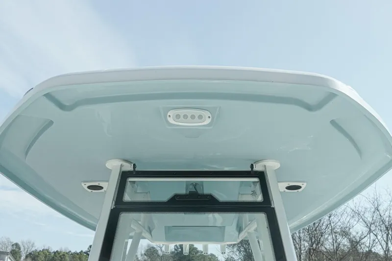 Slide: The Image of 2026 Tidewater 232 CC Adventure boat, featuring a sleek T-top design under a clear sky. - 30