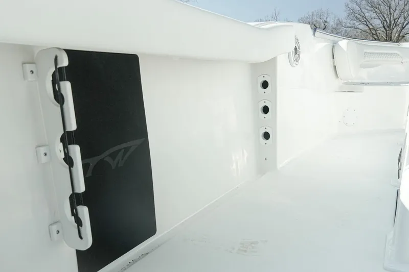 Slide: The Image of 2026 Tidewater 232 CC Adventure boat interior, featuring sleek white design and storage compartments. - 31