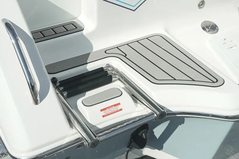 Slide: The Image of 2026 Tidewater 232 CC Adventure boat deck with retractable ladder and non-slip surface. - 33