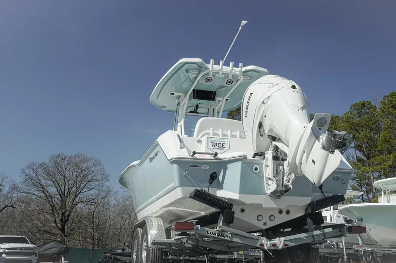 Slide: The Image of 2026 Tidewater 232 CC Adventure boat on trailer, featuring Yamaha engine, under clear blue sky. - 37