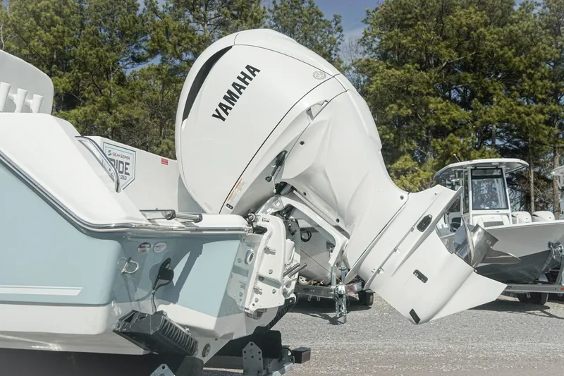 Slide: The Image of 2026 Tidewater 232 CC Adventure boat with Yamaha outboard motor, parked outdoors. - 38