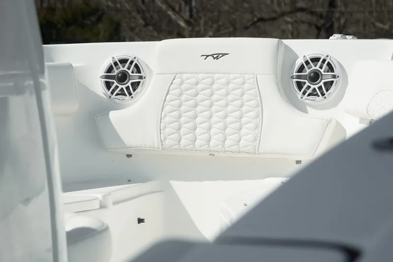 Slide: The Image of 2026 Tidewater 232 CC Adventure boat interior with speakers and quilted seating. - 41