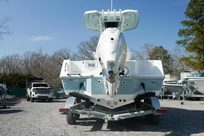 Slide: The Image of 2026 Tidewater 232 CC Adventure boat on trailer, rear view, outdoors. - 44