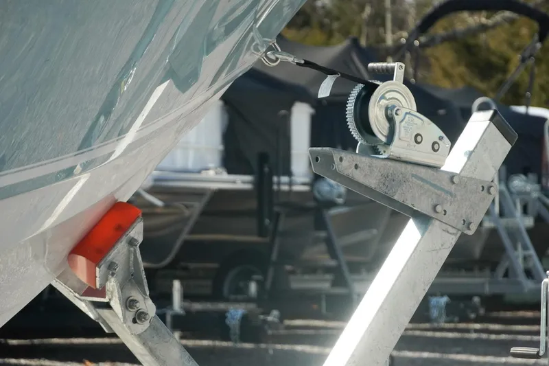 Slide: The Image of 2026 Tidewater 232 CC Adventure boat on trailer with winch mechanism. - 45