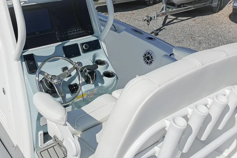 Slide: The Image of 2026 Tidewater 232 CC Adventure boat interior with steering wheel and control panel. - 48